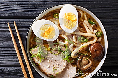 Traditional Japanese udon noodle soup with pork, boiled eggs, mu Stock Photo