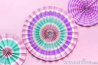 Traditional Japaneses festival paper fan with pink, turquoise, white stripes Birthday party, celebration holidays concept Abstract Stock Photo