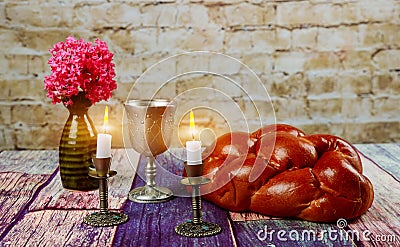 Traditional Jewish Sabbath Shalom ritual fresh challah bread on kiddush cup of red kosher wine Stock Photo