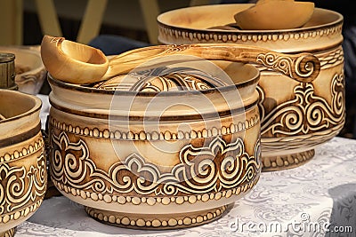 Traditional Kazakh wooden tableware with national ornament is sold on the market Stock Photo