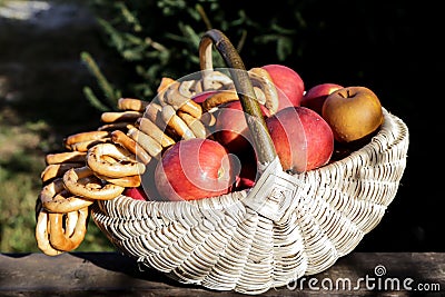 Traditional knit basket full of apples and pretzels Stock Photo