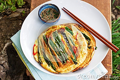 Traditional Korean fritters with green onions and chili, served with soy sauce Stock Photo