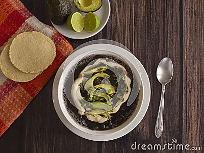 Traditional Latinamerica Black Beans Soup with Avocado and Cream including Homemade Flat Tortilla Stock Photo