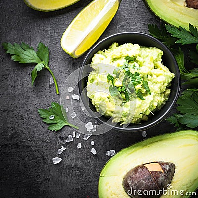 Traditional latinamerican mexican sauce guacamole on black. Stock Photo