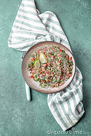 Traditional Lebanese salad tabouli tabule with quinoa, herbs, tomatoes, mint and lemon Stock Photo