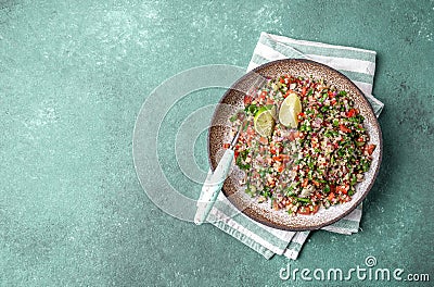 Traditional Lebanese salad tabouli tabule with quinoa, herbs, tomatoes, mint and lemon Stock Photo