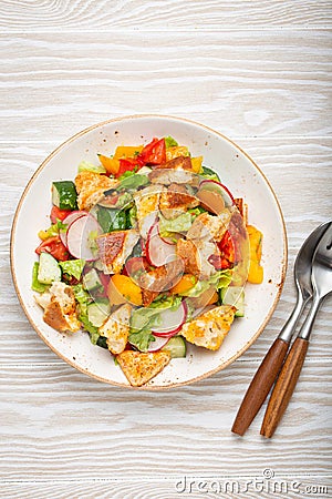 Traditional Levant dish Fattoush salad, Arab cuisine, with pita bread croutons, vegetables, herbs. Healthy Middle Stock Photo