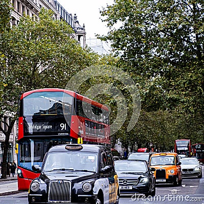 Traditional London Taxiâ€™s And Red Double Desker Bus On A Road Editorial Stock Photo