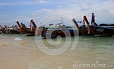 Traditional Thai boats moored at the beach of one of the paradise islands Editorial Stock Photo