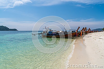 Traditional long tail boats in crystal clear water in Sai Khao Beach, Ra Wi Island, Southern of Thailand Stock Photo