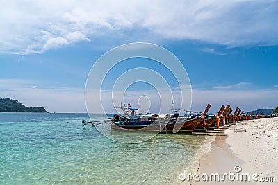 Traditional long tail boats in crystal clear water in Sai Khao Beach, Ra Wi Island, Southern of Thailand Stock Photo