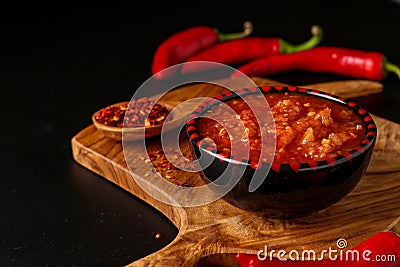 Traditional Maghrebi hot chili pepper sauce paste harissa on dark background, Tunisia and Arabic cuisine , horizontal orientation Stock Photo