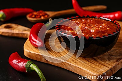 Traditional Maghrebi hot chili pepper sauce paste harissa on dark background, Tunisia and Arabic cuisine , horizontal orientation Stock Photo