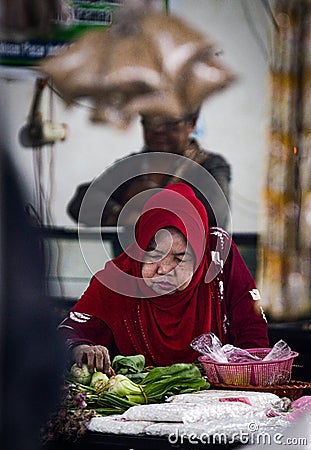 traditional market 10 january 2020 bondowoso, indonesia. In everyday life, Painem sells vegetables in the market. Editorial Stock Photo