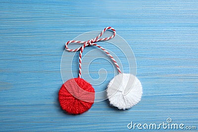 Traditional martisor on blue wooden background, top view. Beginning of spring celebration Stock Photo