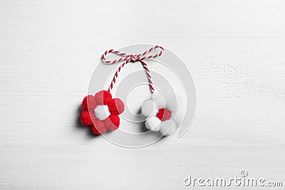 Traditional martisor with flowers on white wooden background, top view. Beginning of spring celebration Stock Photo