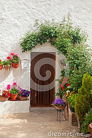 Traditional mediterranean house door decorated flower Stock Photo