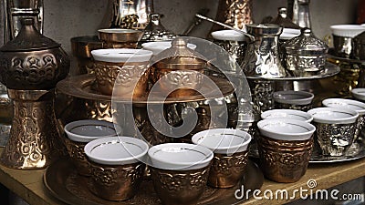 Traditional metal souvenirs at souvenir shop. Copper coffee mugs. Eastern authentic oriental cups Stock Photo