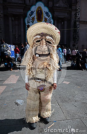 Traditional Mexican dancer known as Chinelo, outside a church, these types of masks are used in the center of Mexico in the Temac Editorial Stock Photo