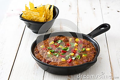 Traditional mexican tex mex chili con carne in a frying pan on white wood Stock Photo