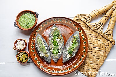 Mexican tlacoyos with green sauce Stock Photo
