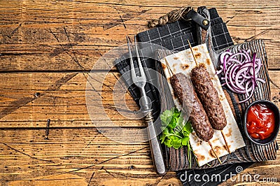 Traditional middle east kefta, kofta kebab from ground beef and lamb meat grilled on skewers served with flatbread and Stock Photo