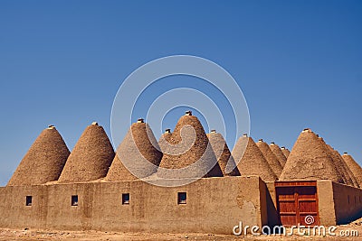 Beehive houses opposite bright clear sky Stock Photo