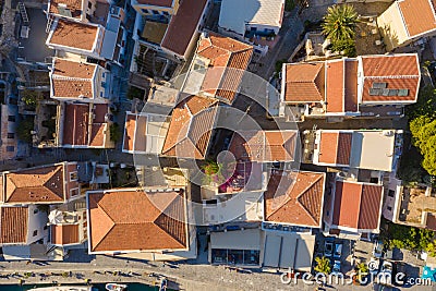 Traditional multicolored historic Greek houses with beautiful roofs of the island city top view from drone. dense Stock Photo