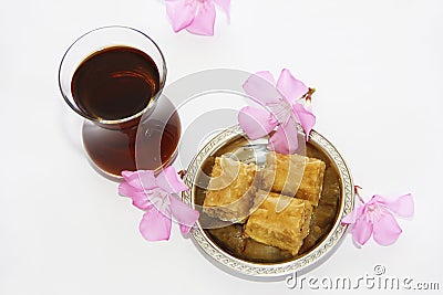 Traditional national Turkish sweetness baklava on decorative plate and a glass of tea Stock Photo