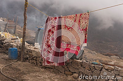 Traditional Nepali Village life. Airing rugs before winter Editorial Stock Photo