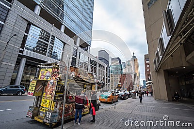 Traditional North American food truck with people ordering food in Downtown Toronto, Ontario, selling burgers, fries and poutine Editorial Stock Photo