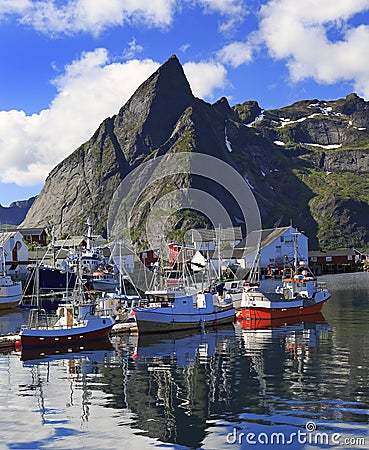 Traditional Norwegian fishing boats in Lofoten Island, Reine area with nice reflections in the ocean Stock Photo