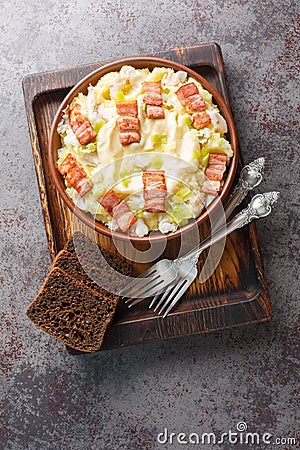 Traditional norwegian stewed fish plukkfisk with potatoes, bacon and onions cooked in a bechamel sauce close up on a plate on the Stock Photo