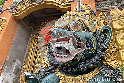 Traditional old ancient Balinese statue of demon angel called barong bali guarding sacred ritual temple Stock Photo