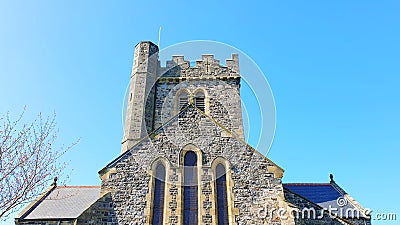 Traditional old historic church architecture found in the UK against a clear blue sky Stock Photo