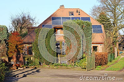 Ancient house with modern alternative solar panels, Netherlands Stock Photo