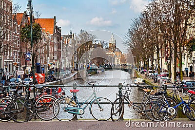 Traditional old houses, canal, bridge, bikes in Amsterdam, Netherlands Editorial Stock Photo