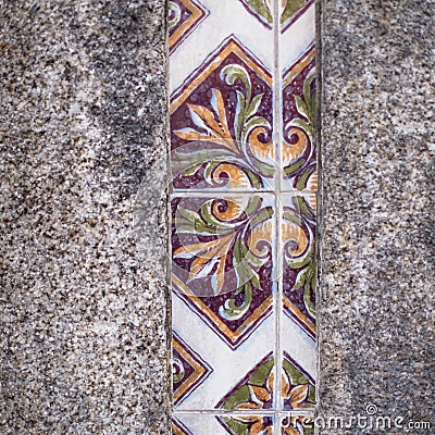 Traditional old tiles wall on the street Portuguese painted tin-glazed, azulejos ceramic tilework. Stock Photo