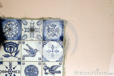 Traditional old tiles wall on the street Portuguese painted tin-glazed, azulejos ceramic tilework. Stock Photo