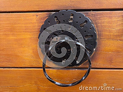 Traditional old vintage ornament on a wooden door. Traditional Ottoman style door bell for ringing on the door Stock Photo