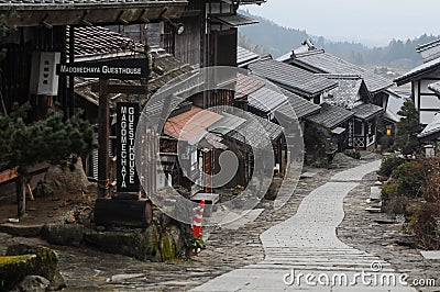 Traditional old wooden houses with a twisting path in Magome juku Editorial Stock Photo