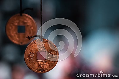 Traditional oriental miniature fortune coins made into necklaces, ready to sell. Stock Photo