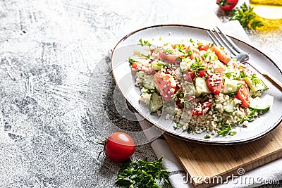 Traditional oriental salad Tabouleh. Tabule cous cous salad with vegetables. Tabbouleh with bulgur Stock Photo