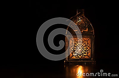 Traditional ornamental arabic candle in dark light. Stock Photo