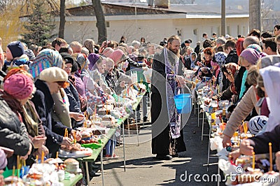 Traditional orthodox paschal ritual - priest blessing easter egg Editorial Stock Photo