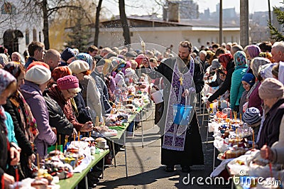 Traditional orthodox paschal ritual - priest blessing easter egg Editorial Stock Photo