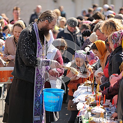 Traditional orthodox paschal ritual - priest blessing easter egg Editorial Stock Photo