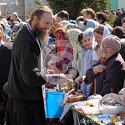 Traditional orthodox paschal ritual - priest blessing easter egg Editorial Stock Photo