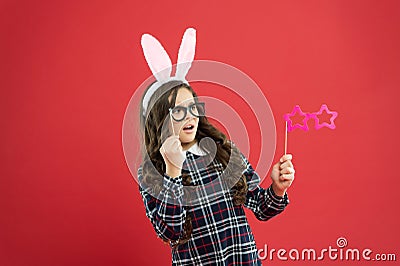 Traditional party activities. Smart bunny. Eyewear booth props. Little cute bunny. Having fun. Girl in Easter bunny at Stock Photo