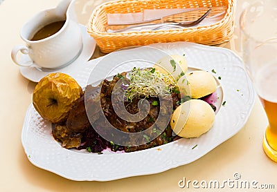 Duck with braised cabbage blue and yeast dumplings Stock Photo